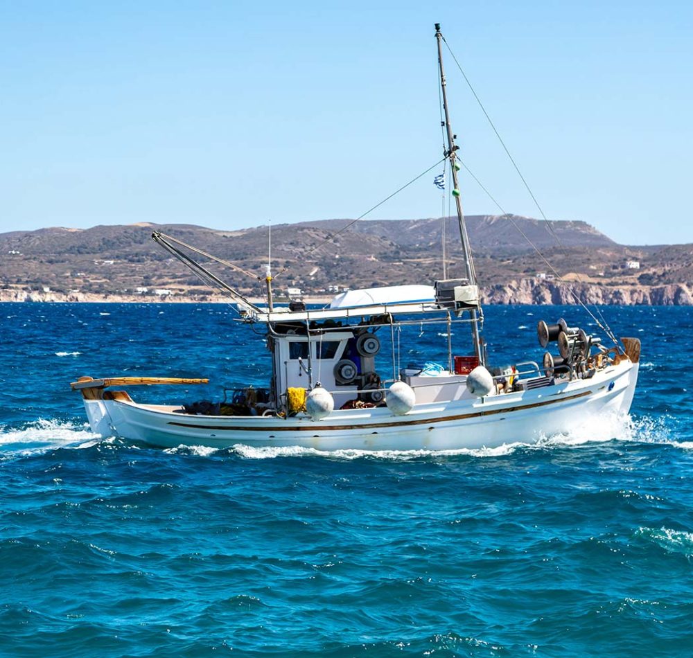 fishing-boat-moving-in-wavy-sea-cyclades-greece-resize.jpg